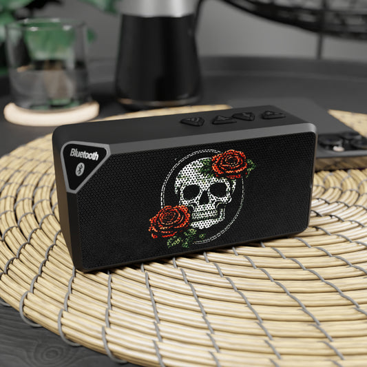 a skull and rose bluetooth speaker displayed on a table